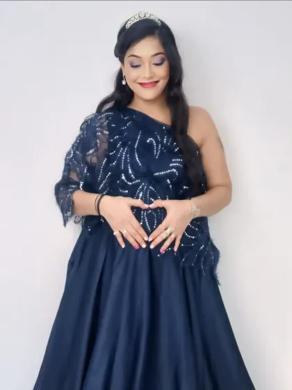 Elegant and refined, this navy blue gown features a one-shoulder design with intricate silver sequin detailing on a delicate lace overlay.