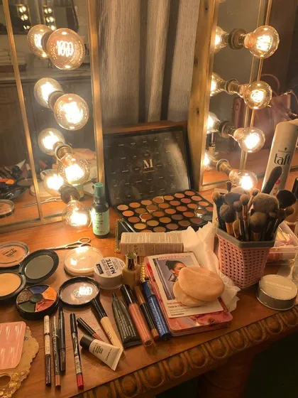 My makeup station, all set up and ready to go in front of a classic vanity mirror. An organized kit is essential for working efficiently on a busy set.