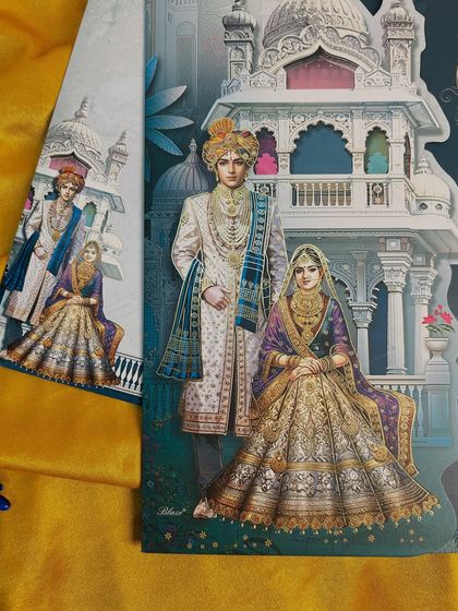 The full view of a regal invitation suite, featuring a portrait of a royal couple set against a backdrop of traditional architecture.