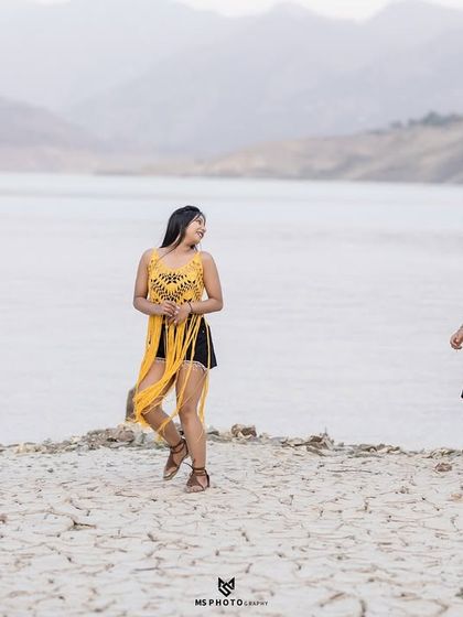 A playful, candid moment of the couple running and laughing on the dry lakebed. It shows their fun-loving personalities in a unique setting.
