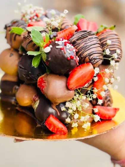 Our Dipped Chocolate Strawberry Cube, a stunning centerpiece for any celebration. This tower of chocolate-covered strawberries is both a visual treat and a delicious indulgence.