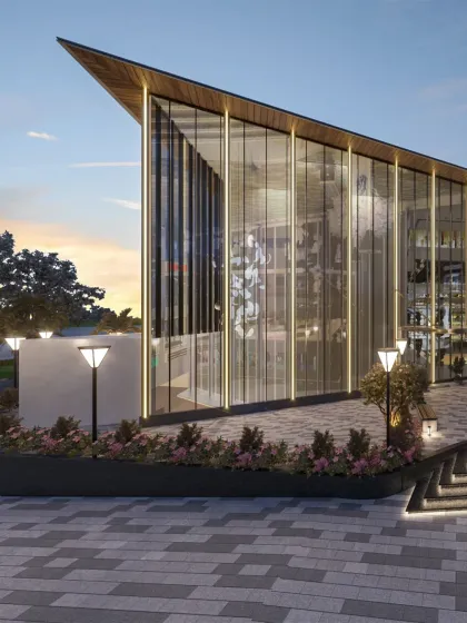 A corner view of the mall's entrance, highlighting the tall, angled glass facade that creates a transparent and inviting entry point.