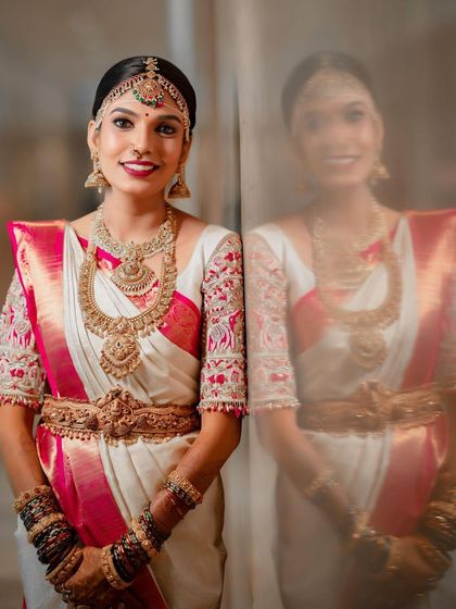 A full portrait showcasing the entire Muhurtham ensemble. The makeup ties together the intricate blouse, heavy temple jewellery, and beautiful Kanchipuram saree for a cohesive and regal look.