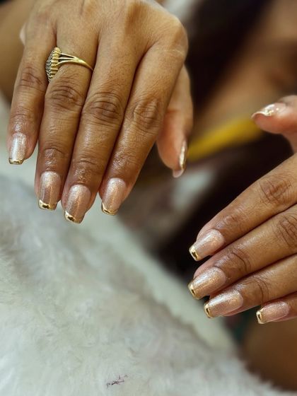 Another look at the beautiful and subtle shimmery nails with gold French tips.