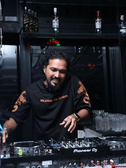 Mixing on my Pioneer DJ console, surrounded by the club atmosphere. This is my office, and I love every minute of it.