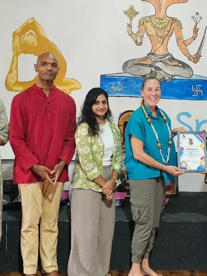 A student from our international workshop receives her certificate of completion.