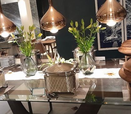 An elegant buffet under statement copper lighting, showing how I work with your home's decor to create a cohesive and beautiful dining environment.