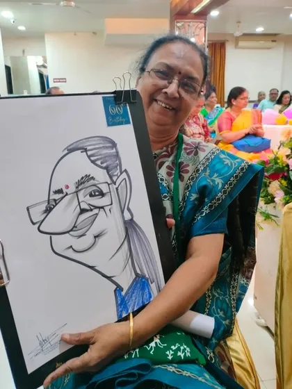A guest at the Hotel Shreyas event, delighted with her caricature. The joy on her face is wonderful to see.