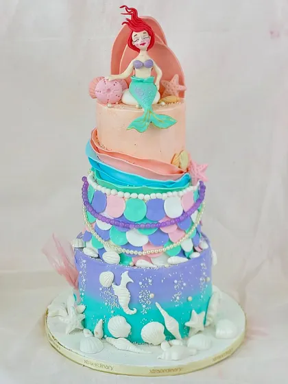 Let's go under the sea! This multi-tiered mermaid cake is a deep-sea dream, with colorful scales, seashell details, and a beautifully sculpted Ariel on top.