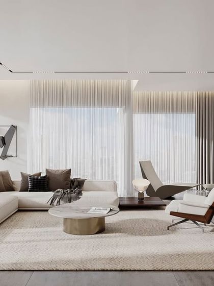 A space that makes you pause and relax. This living room uses a neutral color palette, soft lighting from sheer curtains, and a large, comfortable sectional sofa to create an atmosphere of ultimate comfort and well-being.