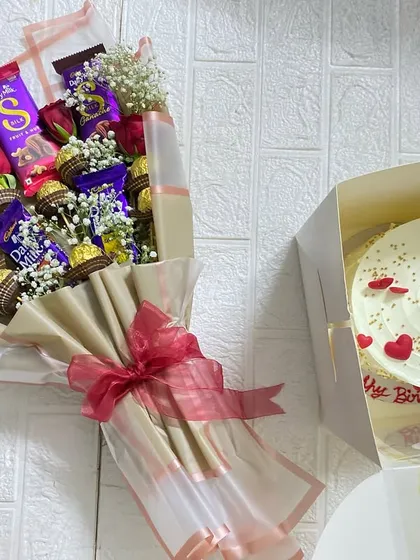 Why choose between cake and gifts when you can have both? Our custom hampers, like this one with a heart-themed cake and a beautiful chocolate bouquet, are the perfect way to make someone's day extra special.
