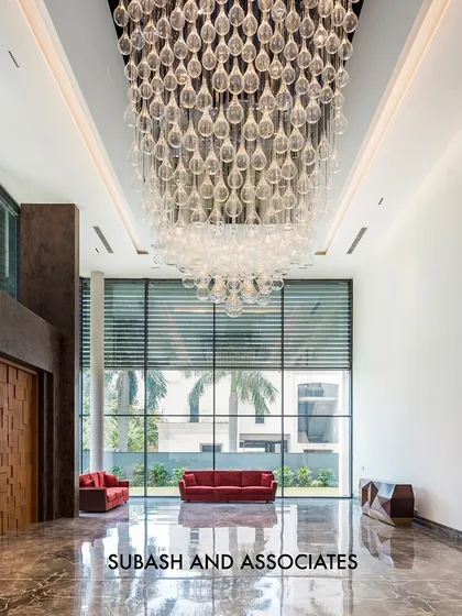 A grand double-height entrance lobby makes a powerful first impression. The massive crystal chandelier and reflective marble floors create an ambiance of pure elegance.