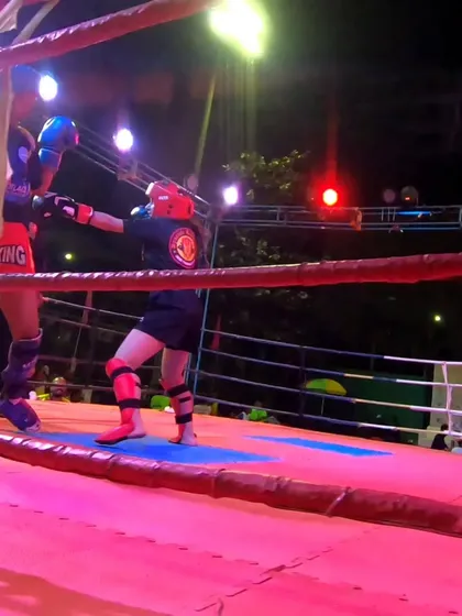 In the ring, our female fighter demonstrates skill and courage, trading blows in a full-contact kickboxing match.