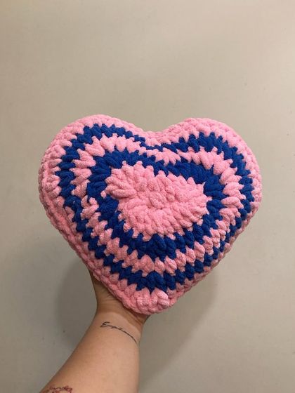 A fun, striped heart-shaped throw pillow to add a pop of color to your room. This one is made with chunky pink and blue yarn, but I can make them in any custom color combination.