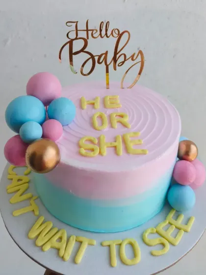"He or She, can't wait to see!" A fun gender reveal cake with pastel pink and blue frosting and bubble decorations.