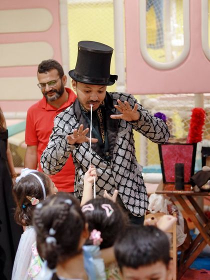 A magician performs a classic trick, captivating his young audience. Our professional entertainers know exactly how to keep kids engaged and mesmerized.