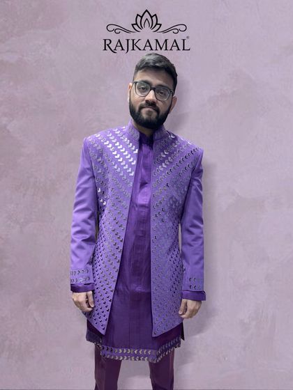 A client looking sharp in the purple cut-work Indo-Western outfit, showing how it looks in a real-world setting.