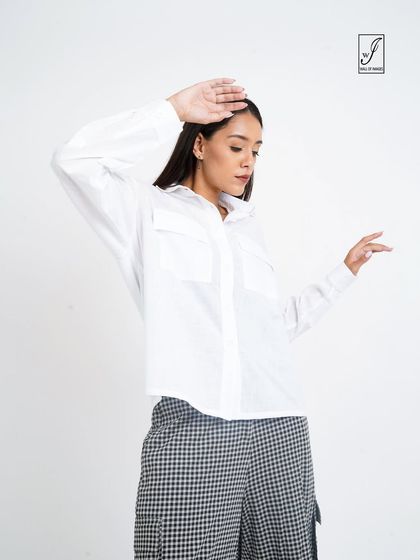 A dynamic pose that adds personality while still clearly displaying the clothing items.