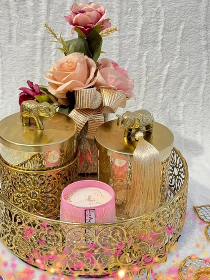 A close-up of my golden Diwali hamper, perfect for adding a touch of royalty to the festivities. The elephant-topped jars and intricate metal tray make it a truly special gift.