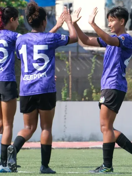 Teammates celebrating a goal together. This is the joy and unity that defines our team on the pitch.