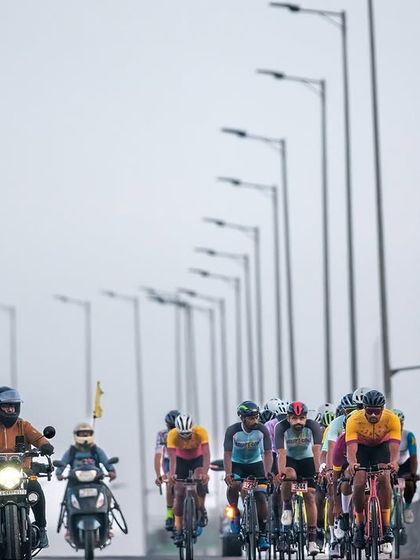 The peloton against a backdrop of streetlights, an interesting perspective on the race.