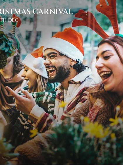 Friends laughing and enjoying the Christmas Carnival. This photo captures the joyful, social atmosphere of our festive events, perfect for making memories with loved ones.