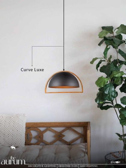 The 'Curve Luxe' pendant combines a black metal dome with a light wood frame. This mix of materials adds warmth and a touch of Scandinavian design sensibility, ideal for a relaxed bedroom or living space.