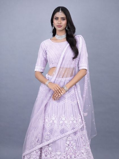 A closer view of the lavender lehenga, allowing you to see the fine details of the threadwork on the blouse and skirt.