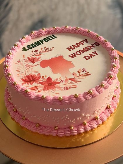 A lovely cake for a corporate Women's Day celebration, featuring the company logo and a beautiful themed design.