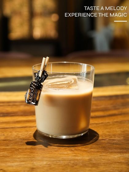 Taste a melody. This playful cocktail, garnished with a Melody toffee, is a nostalgic and creative concoction from one of our limited-edition menus.