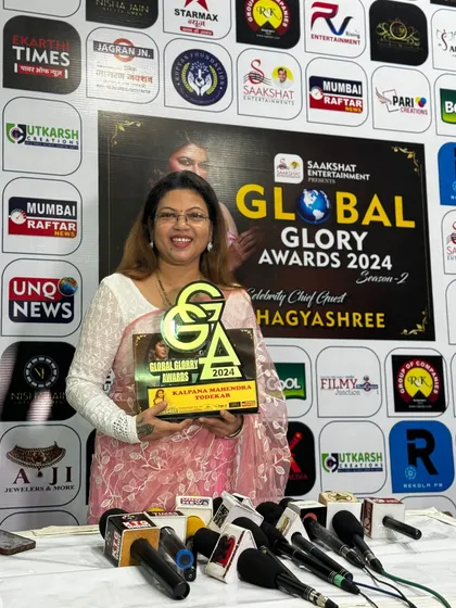 Posing with my Global Glory Award in front of the media wall. Being recognized on such platforms is a testament to my dedication and the quality of training I provide at my academy.