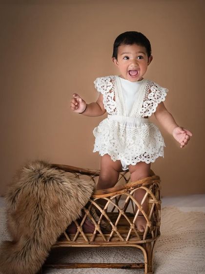 This little cutie with the big, expressive eyes has all my heart. The simple lace romper and the rustic textures of the boho setup create a beautiful, natural portrait.