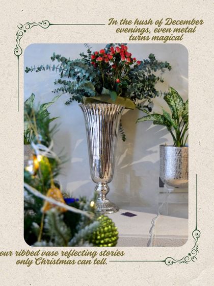 In the hush of December evenings, even metal turns magical. Our ribbed vase reflects the stories only Christmas can tell, seen here with some festive foliage.