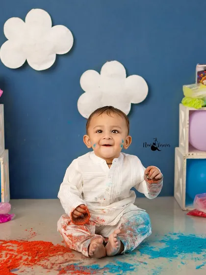 A happy, colorful mess. This little boy's smile shows how much fun he's having during the Holi festival shoot.