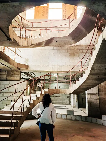 The structural form of a multi-level spiral staircase during construction. This image shows the complex architectural work we undertake, creating dramatic and functional centerpieces for custom homes from the ground up.