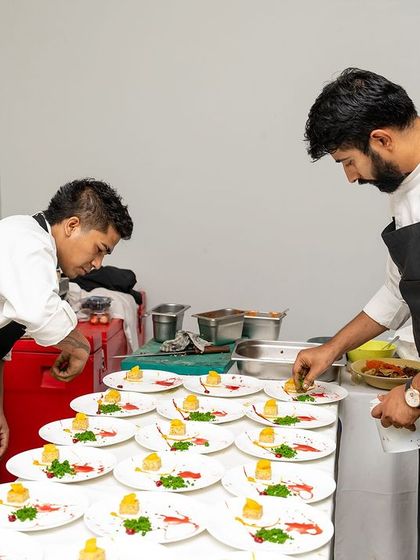 Another shot of our team plating with precision for a large birthday party. We thrive on the energy of events and love bringing culinary visions to life.
