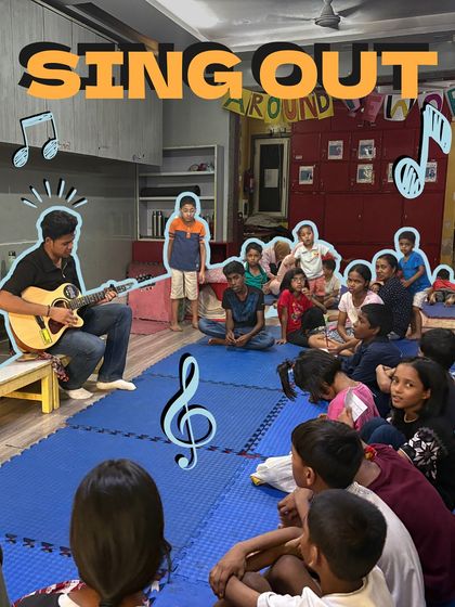 An instructor plays guitar for a captivated audience of young children. Even the youngest learners are drawn in by the magic of live music, making our sessions accessible to all age groups.