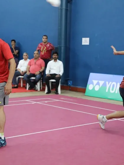 An intense moment in a doubles match, showcasing the high level of competition in the veteran and masters tournaments we manage.