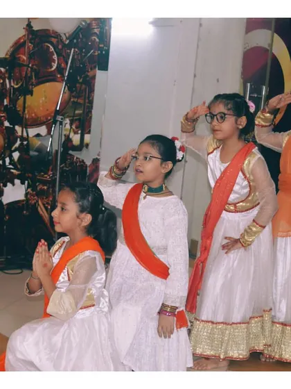 Four of our students in a respectful saluting pose during their performance for a national day event.