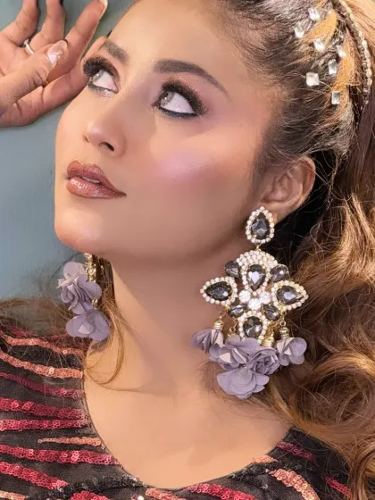 An artistic pose from a creative shoot, looking up to highlight the dramatic eye makeup.