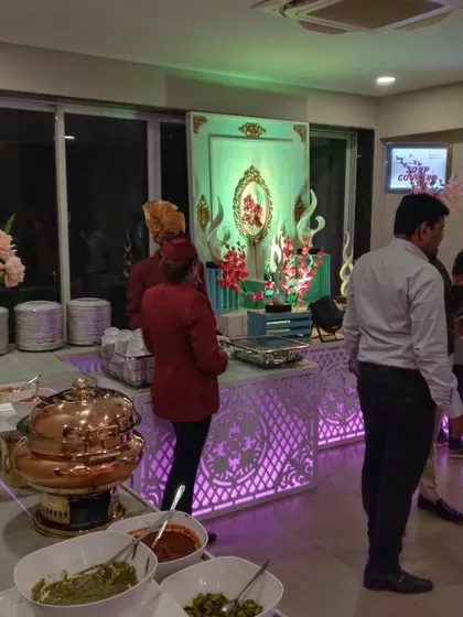 The sweet counter illuminated with soft green lighting to match the event's color scheme. We coordinate every detail of our setup with your overall event design.