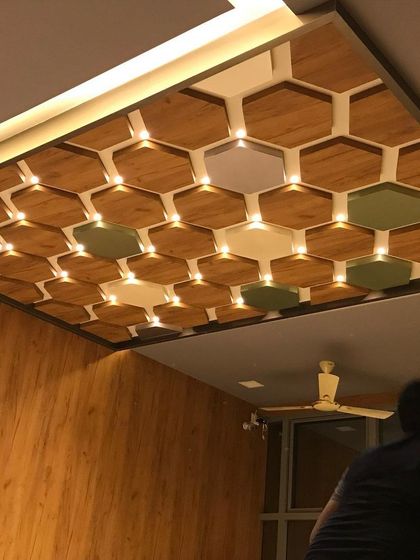 A detailed look at the hexagonal coffered ceiling in the skincare clinic. This intricate design element adds visual interest and conceals lighting, contributing to the space's modern and sophisticated feel.