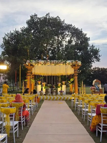 An elegant outdoor Haldi ceremony setup with a South Indian theme. We designed this beautiful mandap with traditional pillars and floral arrangements, creating a serene and picturesque setting for the celebration.