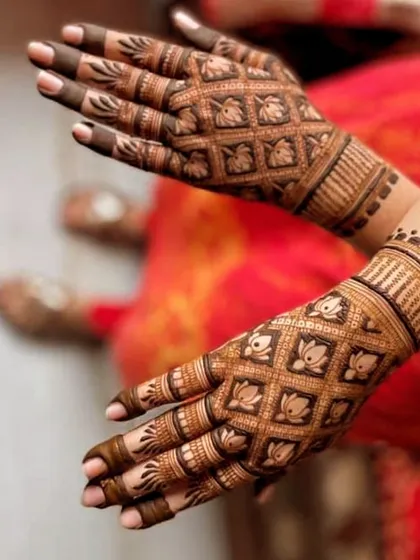 This is a classic jaal pattern, where a net of checks is filled with delicate lotus motifs. It's an elegant and timeless design that looks stunning once the henna stain matures.