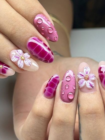 A vibrant and creative 3D nail art set in shades of pink. This design features a crocodile skin texture, sculpted flowers, and realistic water droplet effects.