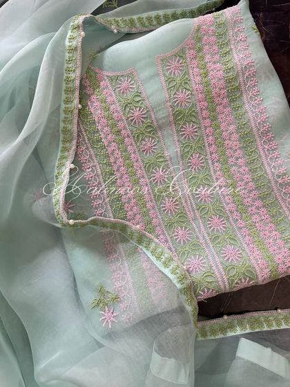 A full view of the laid-out suit, emphasizing its light and airy feel.