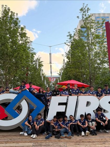 Our teams, Sigma and Kaizen, pose with the iconic FIRST sign at the World Championship in Houston, ready to take on the competition.