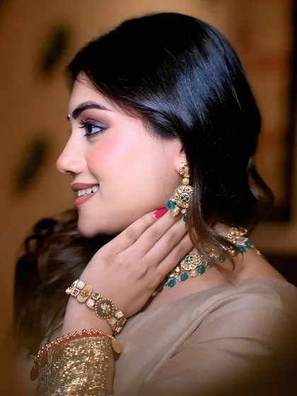 A detailed shot focusing on the intricate jewelry and flawless makeup of a model. This type of photo is crucial for collaborations with jewelers and makeup artists.