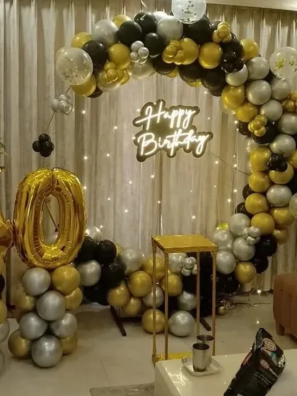 A similar 40th birthday setup, showing the full circular balloon arch in black, gold, and silver, with a neon sign and large number balloons, perfect for milestone celebrations at home.