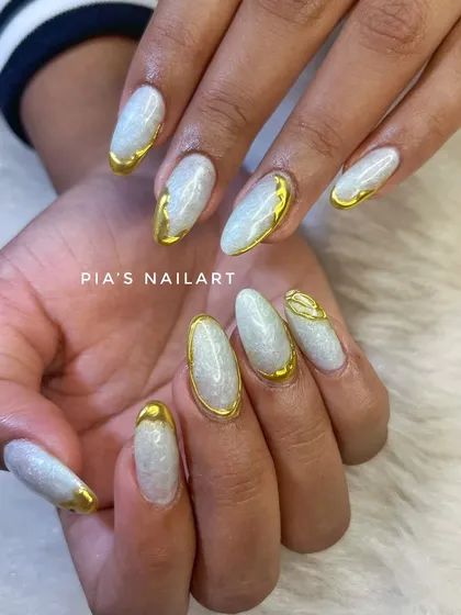 A pearly white base with sculpted gold chrome accents. This design is perfect for a bride or anyone who loves a touch of glamour.